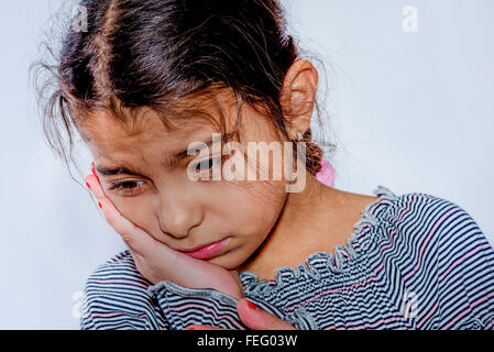 Little girl with toothache in white background