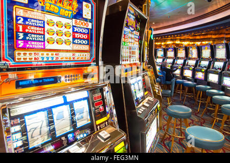 Slot machines in casino on board Royal Caribbean 'Brilliance of the Seas' cruise ship, Mediterranean, Europe Stock Photo