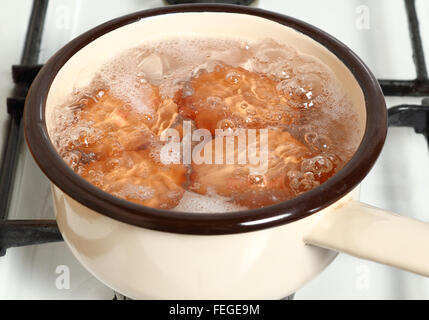 Boiling eggs in saucepan on gas stove Stock Photo
