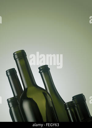 Set of empty wine bottles on green background Stock Photo
