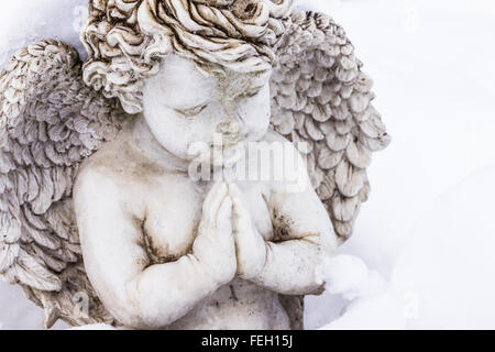 stone sculpture of praying angelr Stock Photo