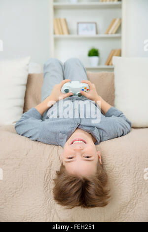 Happy cheerful boy having fun and playing games Stock Photo