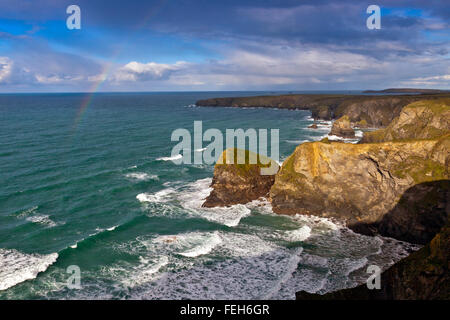 A rainbow over the dramatic sea stacks at Bedruthan Steps on the north coast of Cornwall, England, UK Stock Photo