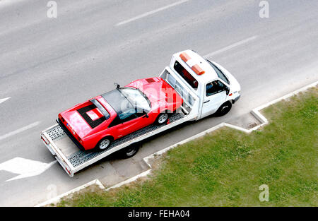 fast oldtimer car on the carrier vehicle Stock Photo