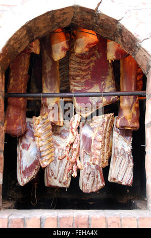 Smoking meat, sausage, bacon and other products in the traditional way Stock Photo