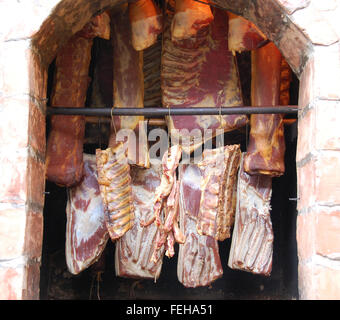 Smoking meat, sausage, bacon and other products in the traditional way Stock Photo