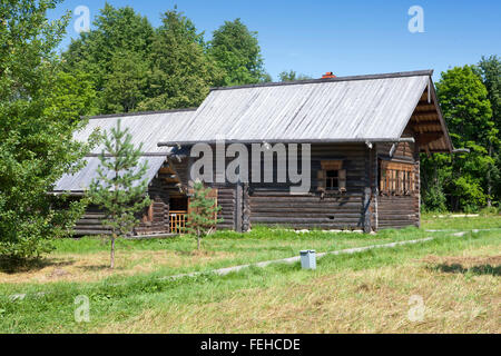 ancient log hut on a forest glade. Russia. Stock Photo