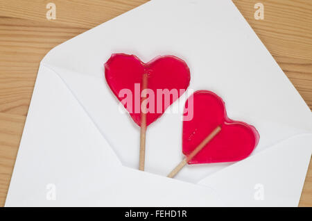 red transparent heart shaped lollipops Stock Photo