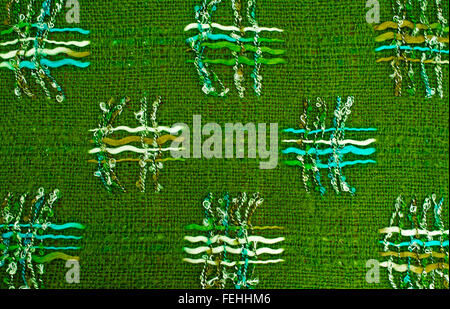 Textured background of a criss cross pattern on a green heavy cloth Stock Photo