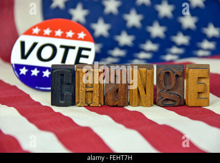 Patriotic vote button and vintage letterpress type on American flag. Stock Photo