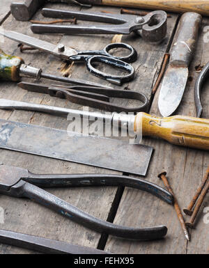 Old and rusty tools on a rustic wooden table Stock Photo