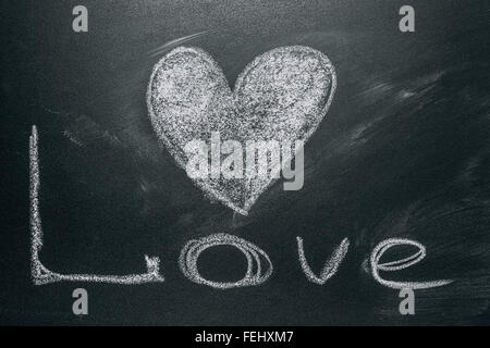 Handwritten message on a school chalkboard drawing with an illustrated heart used as a symbol, concept of love in this Valentine Stock Photo