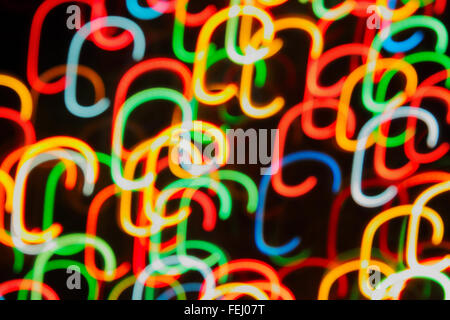 Multi-colored strips of light against a black background Stock Photo