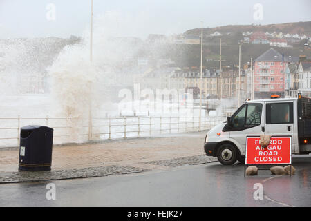 Aberystwyth, Wales, UK. 08th February 2016. UK Weather:  Huge waves battering Aberystwyth as Storm Imogen comes to Town. Council workers block the road along the promenade.  UK weather forecast: Wind gusts widely being around 70 - 80 mph and thundery showers spreading through southern England and Wales. Credit:  Ian Jones/Alamy Live News Stock Photo