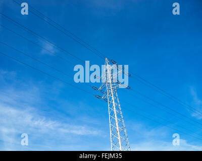 High voltage pylon against blue sky. Stock Photo
