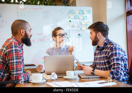 Group of serious young people working on business meeting together Stock Photo