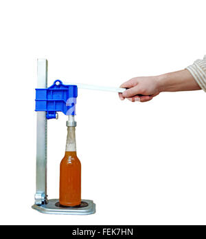 Manual capping machine for bottles on a white background Stock Photo