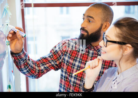 Young business people discussing of something in office Stock Photo