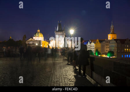 People flock on the Charles Bridge over the Vltava River in Prague during a summer night,Prague,Czech Republic Stock Photo