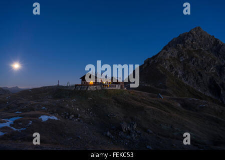 The Fiderepass mountain hut in the Allgaeu Alps at night with the full moon,Bavaria,Oberstdorf,Germany Stock Photo