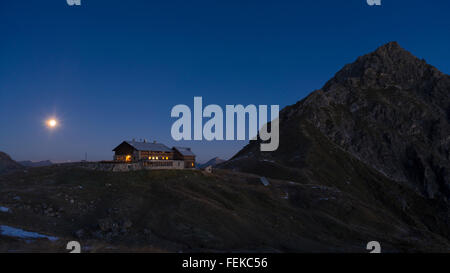 The Fiderepass mountain hut in the Allgaeu Alps at night with the full moon,Bavaria,Oberstdorf,Germany Stock Photo