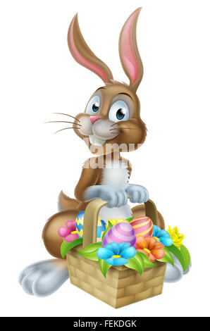 Cartoon Easter bunny rabbit holding an Easter Eggs basket full of chocolate decorated Easter eggs Stock Photo