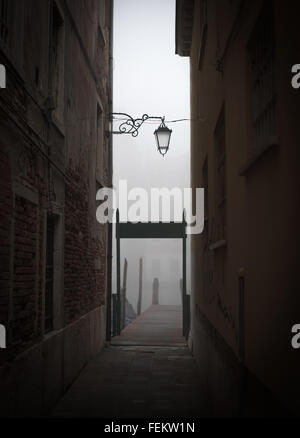 Wooden pier at the end of an alley in Venice Stock Photo