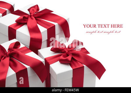 Gift boxes with red ribbons and bows isolated on the white background, clipping path included. Stock Photo