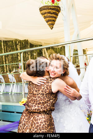 Bride Hugging Sister On Wedding Day Stock Photo