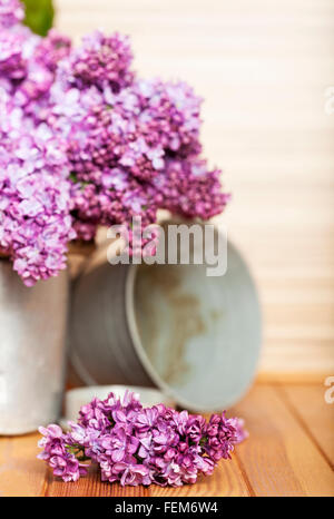 rustic still life with lilac in a glass vase and daisies wooden ...