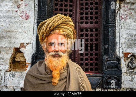 Wandering  sadhu baba (holy man) with traditional long hair in ancient Pashupatinath Temple Stock Photo