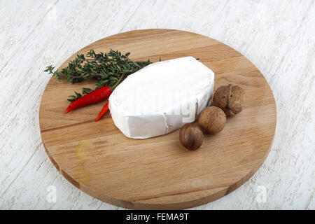 Brie cheese with thyme leaves and nuts Stock Photo