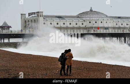 Brighton, UK. 8th February, 2016. UK Weather: These young women try to take a selfie photograph on Brighton beach as Storm Imogen batters the south coast today with the weather forecast predicting wind speeds of up to 90 mph causing widespread flooding and damage  Credit:  Simon Dack/Alamy Live News Stock Photo