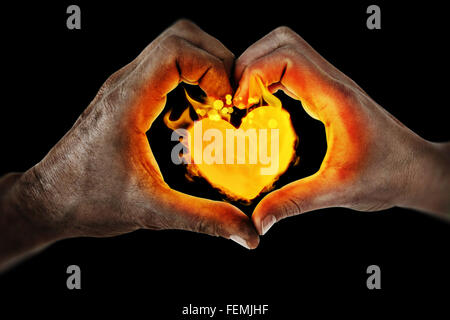 Composite image of couple making heart shape with hands Stock Photo