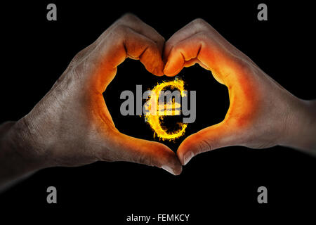 Composite image of couple making heart shape with hands Stock Photo