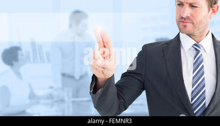 Composite image of businessman pointing with his finger Stock Photo
