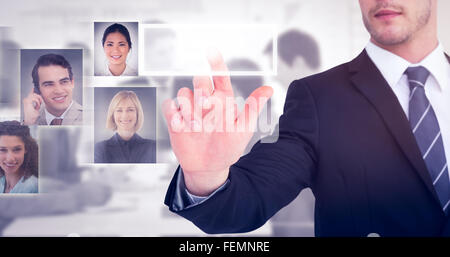 Composite image of focused businessman pointing with his finger Stock Photo