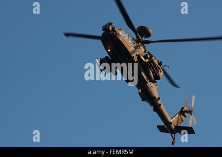 AgustaWestland Apache attack helicopter flown by the British Army Air Corps on a training mission over Woodbridge airfield. Stock Photo