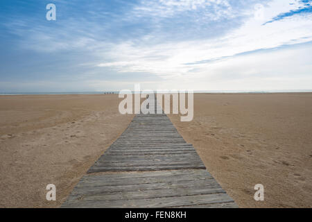 wooden boardwalk across a sandy beach Stock Photo