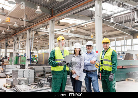 Portrait confident engineers and workers in steel factory Stock Photo
