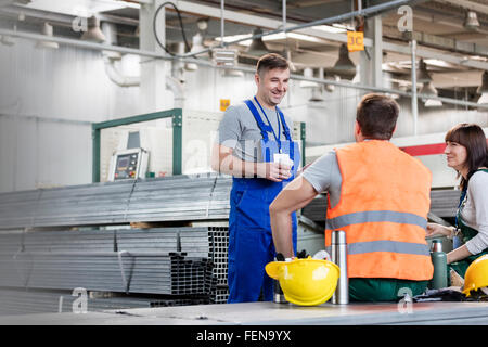 Workers enjoying coffee break in steel factory Stock Photo