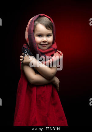 Cute child shivering in the cold isolated on black Stock Photo