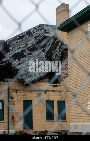 A collapsed roof is seen through a chain link fence at Fort Hancock on Sandy Hook in New Jersey Stock Photo