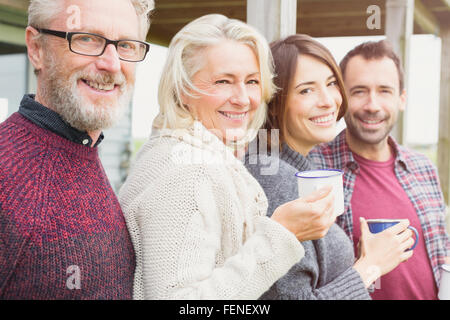 Portrait smiling couples drinking coffee outdoors Stock Photo