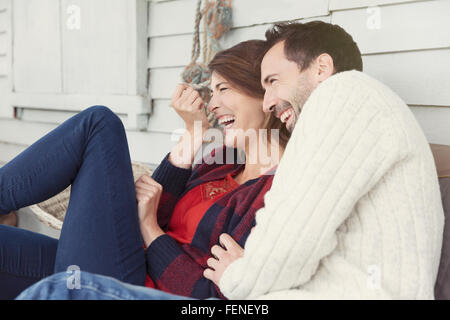 Laughing couple on patio Stock Photo