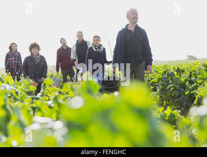 Multi-generation family walking in sunny vegetable garden Stock Photo