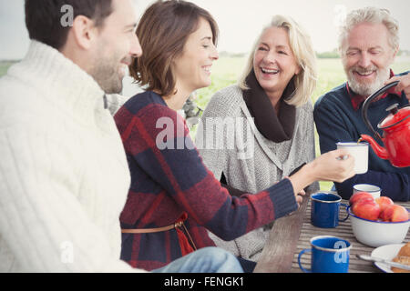 Couples drinking coffee on patio Stock Photo
