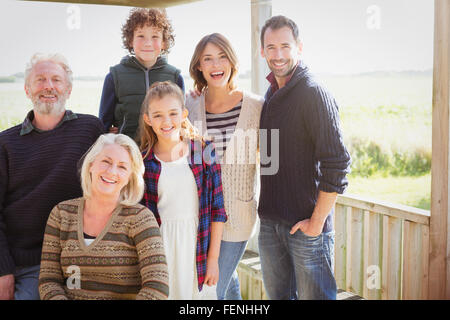 Portrait smiling multi-generation family on sunny porch Stock Photo