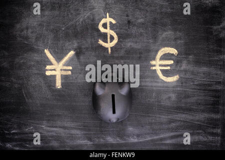 Black piggy bank and Currency signs (Euro, Dollar, Yen). Vignette. Stock Photo