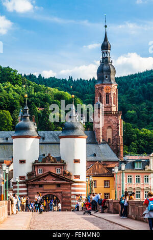The towers and gate at the southern end of the Karl-Theodor-Brucke or Old Bridge in Heidelberg with the Heiliggeistkirche spire. Stock Photo
